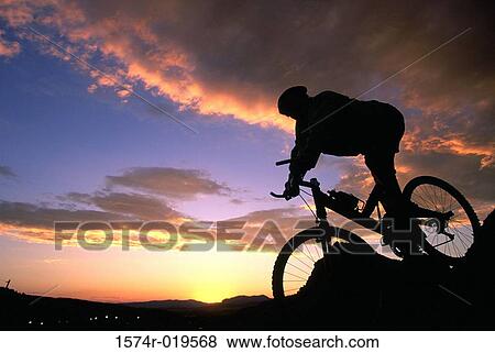 Silhouette of a person mountain biking View Large Photo Image Stock Photo - Silhouette of a person mountain biking. Fotosearch