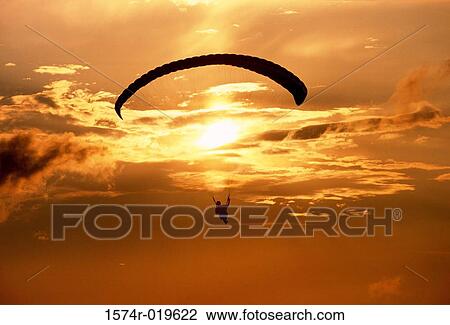 Silhouette of a person paragliding at dusk View Large Photo Image Stock Image - Silhouette of a person paragliding at dusk. Fotosearch