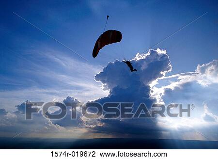 Silhouette of a person paragliding View Large Photo Image Stock Image - Silhouette of a person paragliding. Fotosearch