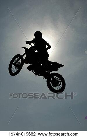 Silhouette of a person performing stunts on a motorcycle View Large Photo Image Stock Image - Silhouette of a person performing stunts on a motorcycle. Fotosearch