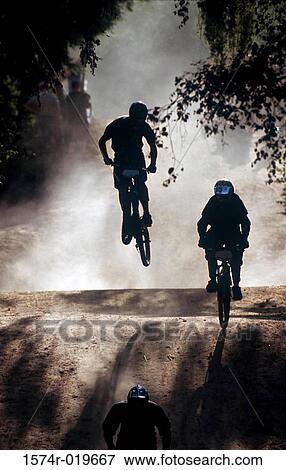 Silhouette of three people cycling in a race View Large Photo Image Stock Photo - Silhouette of three people cycling in a race. Fotosearch