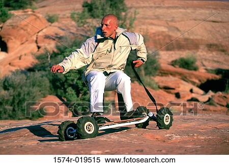 Young man mountain boarding View Large Photo Image Stock Photography - Young man mountain boarding. Fotosearch