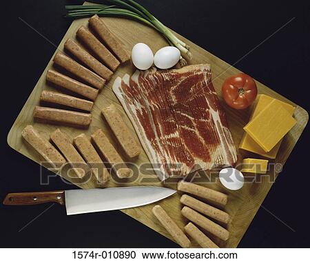 Stock Image - Assortment of raw meats on a cutting board. Fotosearch