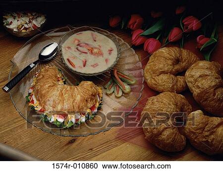 Stock Image - Bowl of soup served with croissants. Fotosearch