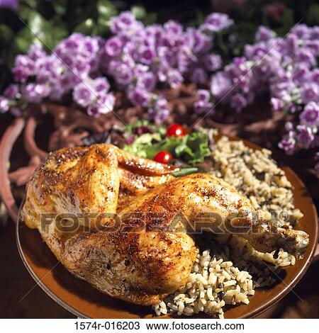 Stock Image - Close-up of chicken and rice on a plate. Fotosearch