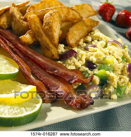 Close-up of scrambled eggs with potato wedges on a plate View Large Photo Image Stock Photo - Close-up of scrambled eggs with potato wedges on a plate. Fotosearch