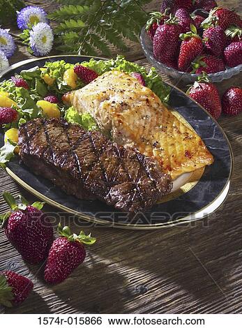 Stock Photograph - Close-up of seafood and steak on a plate. Fotosearch