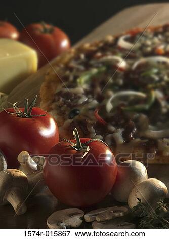 Close-up of tomatoes with a pizza View Large Photo Image Stock Photo - Close-up of tomatoes with a pizza. Fotosearch