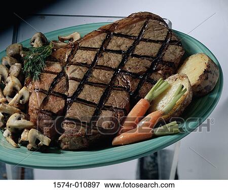 Stock Photo - Grilled beef with mushrooms. Fotosearch