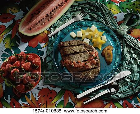 Stock Photography - Grilled meat with strawberries and watermelon. Fotosearch