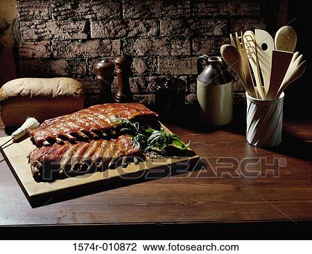 Stock Image - Grilled ribs on a cutting board. Fotosearch