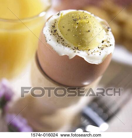 Picture - High angle view of a hard-boiled egg in an eggcup. Fotosearch