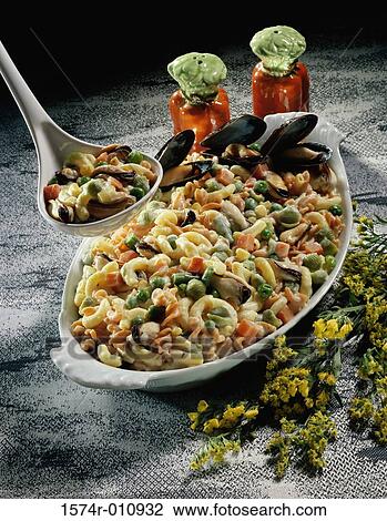Ladle over a casserole of seafood View Large Photo Image Stock Image - Ladle over a casserole of seafood. Fotosearch