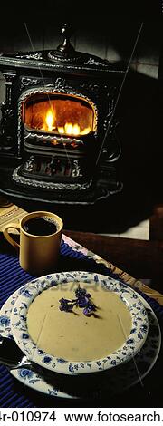Mug of black coffee next to a bowl of soup View Large Photo Image Picture - Mug of black coffee next to a bowl of soup. Fotosearch