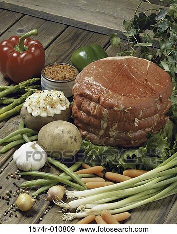 Stock Photo - Raw meat with assorted vegetables. Fotosearch