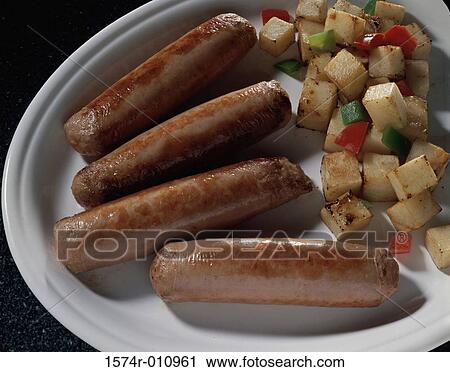 Stock Image - Sausages with potatoes. Fotosearch