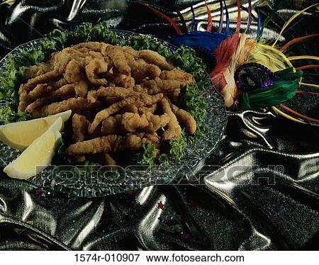 Strips of fried fish served in a plate View Large Photo Image Stock Photo - Strips of fried fish served in a plate. Fotosearch