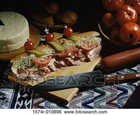 Submarine sandwich on a cutting board View Large Photo Image Stock Photo - Submarine sandwich on a cutting board. Fotosearch