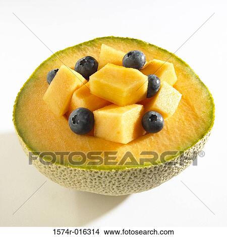 Picture - Close-up of blueberries on half of a cantaloupe. Fotosearch
