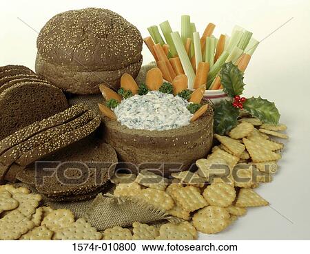 Stock Image - Close-up of brown bread with crackers and dip. Fotosearch