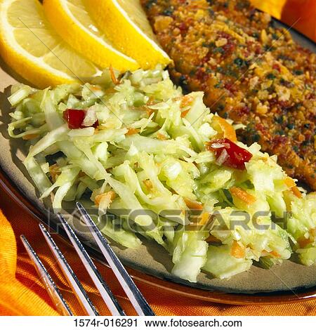 Stock Image - Close-up of cabbage and lemon slices on a plate. Fotosearch