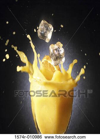Close-up of ice falling into a glass of orange juice View Large Photo Image Stock Photograph - Close-up of ice falling into a glass of orange juice. Fotosearch