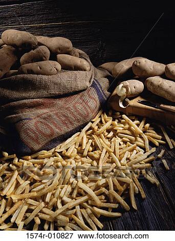 Potatoes in a sack next to French fries View Large Photo Image Stock Photo - Potatoes in a sack next to French fries. Fotosearch