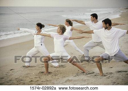 Group of people exercising on the beach View Large Photo Image Stock Image - Group of people exercising on the beach. Fotosearch