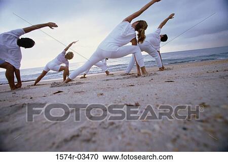 Group of people exercising on the beach View Large Photo Image Stock Image - Group of people exercising on the beach. Fotosearch