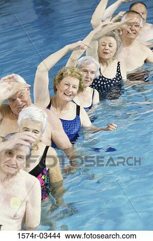 Picture - Group of senior people performing water aerobics in a swimming pool. Fotosearch