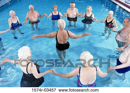 Stock Photo - Group of senior people performing water aerobics in a swimming pool. Fotosearch