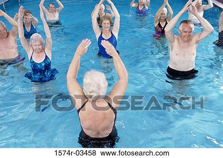 Stock Photo - Group of senior people performing water aerobics in a swimming pool. Fotosearch