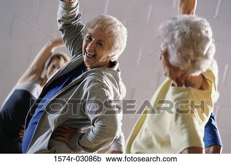 Stock Image - Group of senior women exercising in a health club. Fotosearch