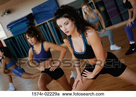 Stock Image - Group of young women exercising in an aerobics class. Fotosearch