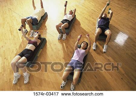 Stock Photo - High angle view of a group of people exercising in a step aerobics class. Fotosearch
