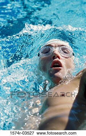 High angle view of a young man swimming the backstroke View Large Photo Image Stock Photo - High angle view of a young man swimming the backstroke. Fotosearch