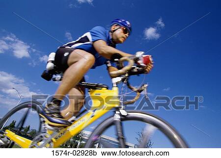 Low angle view of a mature man riding a bicycle View Large Photo Image Stock Image - Low angle view of a mature man riding a bicycle. Fotosearch