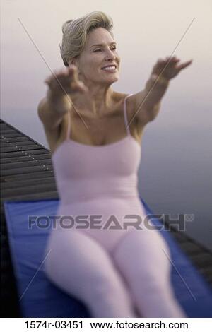 Mid adult woman exercising View Large Photo Image Stock Image - Mid adult woman exercising. Fotosearch