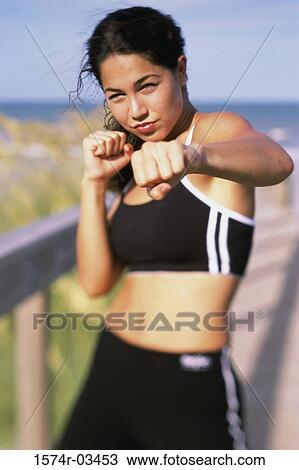 Portrait of a young woman boxing View Large Photo Image Stock Image - Portrait of a young woman boxing. Fotosearch