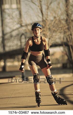 Stock Photo - Portrait of a young woman skating. Fotosearch
