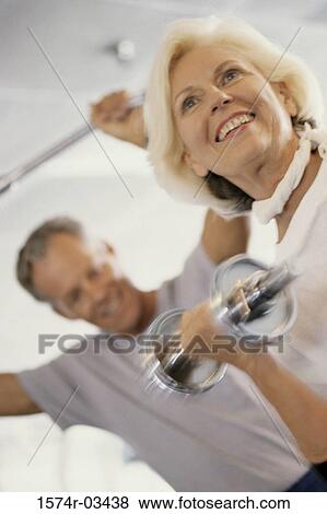 Stock Photo - Senior couple exercising in a health club. Fotosearch