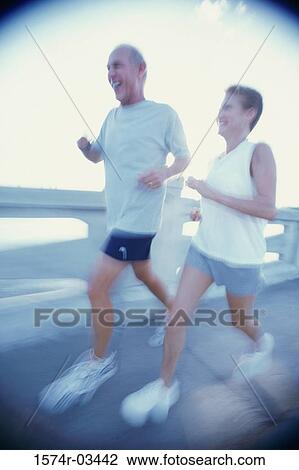 Senior couple jogging on a bridge View Large Photo Image Stock Image - Senior couple jogging on a bridge. Fotosearch