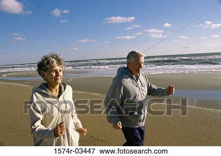 Senior couple walking on the beach View Large Photo Image Stock Photo - Senior couple walking on the beach. Fotosearch