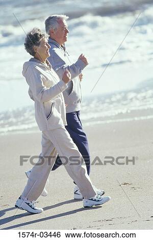 Senior couple walking on the beach View Large Photo Image Stock Photograph - Senior couple walking on the beach. Fotosearch