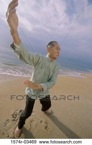 Senior man practicing Tai Chi on the beach View Large Photo Image Stock Photo - Senior man practicing Tai Chi on the beach. Fotosearch