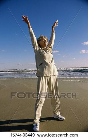 Senior woman exercising on the beach View Large Photo Image Stock Photo - Senior woman exercising on the beach. Fotosearch