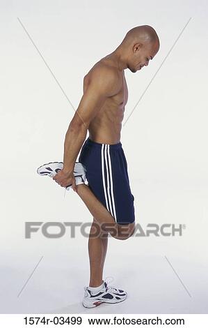 Side profile of a young man holding his leg View Large Photo Image Stock Photo - Side profile of a young man holding his leg. Fotosearch