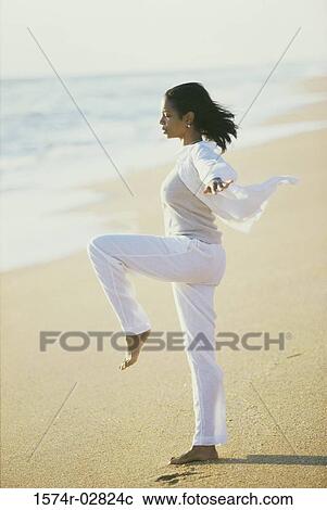 Side profile of a young woman meditating on the beach View Large Photo Image Stock Image - Side profile of a young woman meditating on the beach. Fotosearch