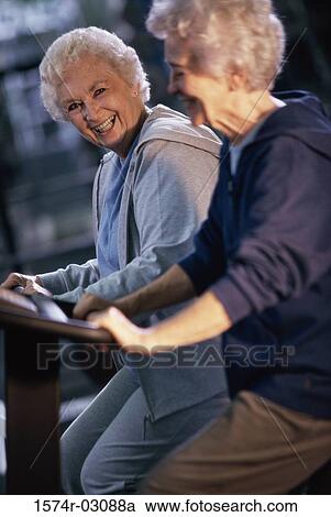 Stock Image - Two senior women exercising in a health club. Fotosearch