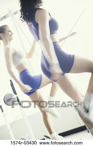 Two young women exercising in a health club View Large Photo Image Stock Image - Two young women exercising in a health club. Fotosearch